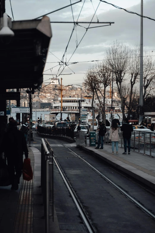 a group of people waiting at a train station, by irakli nadar, pexels contest winner, happening, city view, istanbul, 🚿🗝📝