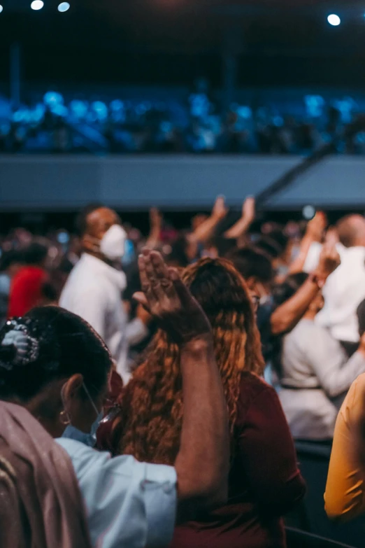 a group of people standing in front of a crowd, it is a place of worship