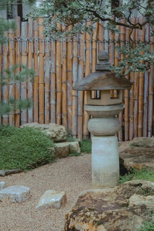 a stone lantern sitting in the middle of a garden, inspired by Katsukawa Shunsen, sōsaku hanga, bamboo wood, exterior, high textured