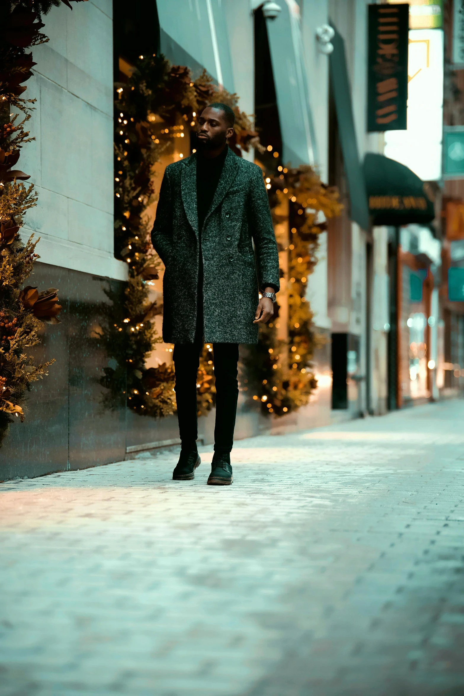 a man walking down a street at night, trending on pexels, wearing festive clothing, wearing a long coat, doing an elegant pose over you, tights; on the street