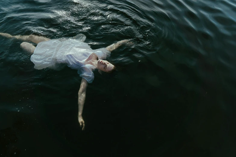a man floating on top of a body of water, an album cover, inspired by Brooke Shaden, pexels contest winner, renaissance, monia merlo, on black background, rinko kawauchi, concerned