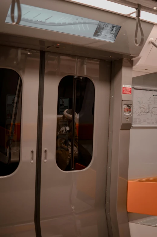 a view of the inside of a subway car, by Adam Manyoki, gray and orange colours, about to enter doorframe, theater dressing room, orange metal ears