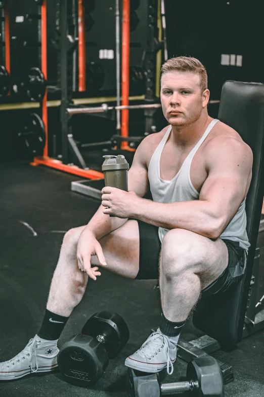 a man sitting on a bench in a gym, by Ryan Pancoast, albino white pale skin, thicc build, instagram post, dustin lefevre