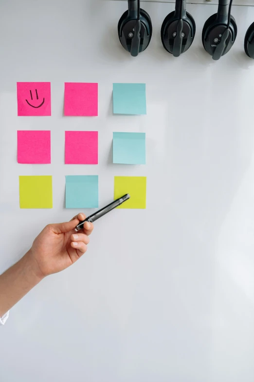 a person standing in front of a whiteboard with post it notes on it, detailed product shot, teaser, square sticker, top