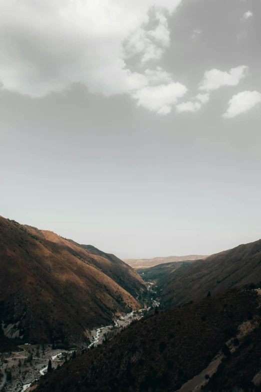 a view of a valley from the top of a hill, by Otto Meyer-Amden, unsplash contest winner, les nabis, in muted colors, small village, slightly pixelated, canyons