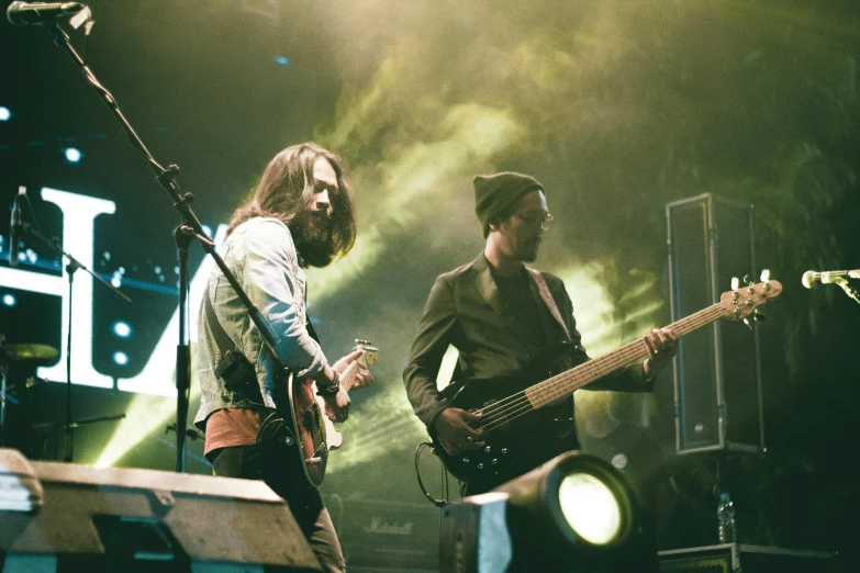 a couple of men standing next to each other on a stage, pexels contest winner, jonny greenwood (lead guitar), tesseract, playing guitars, the scooter ( edm band