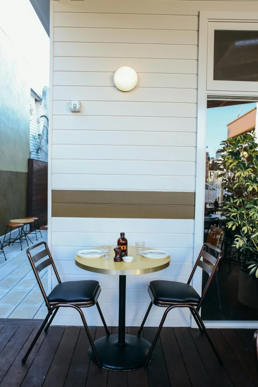 a couple of chairs sitting on top of a wooden floor, eating outside, hollywood standard, chef table, profile image