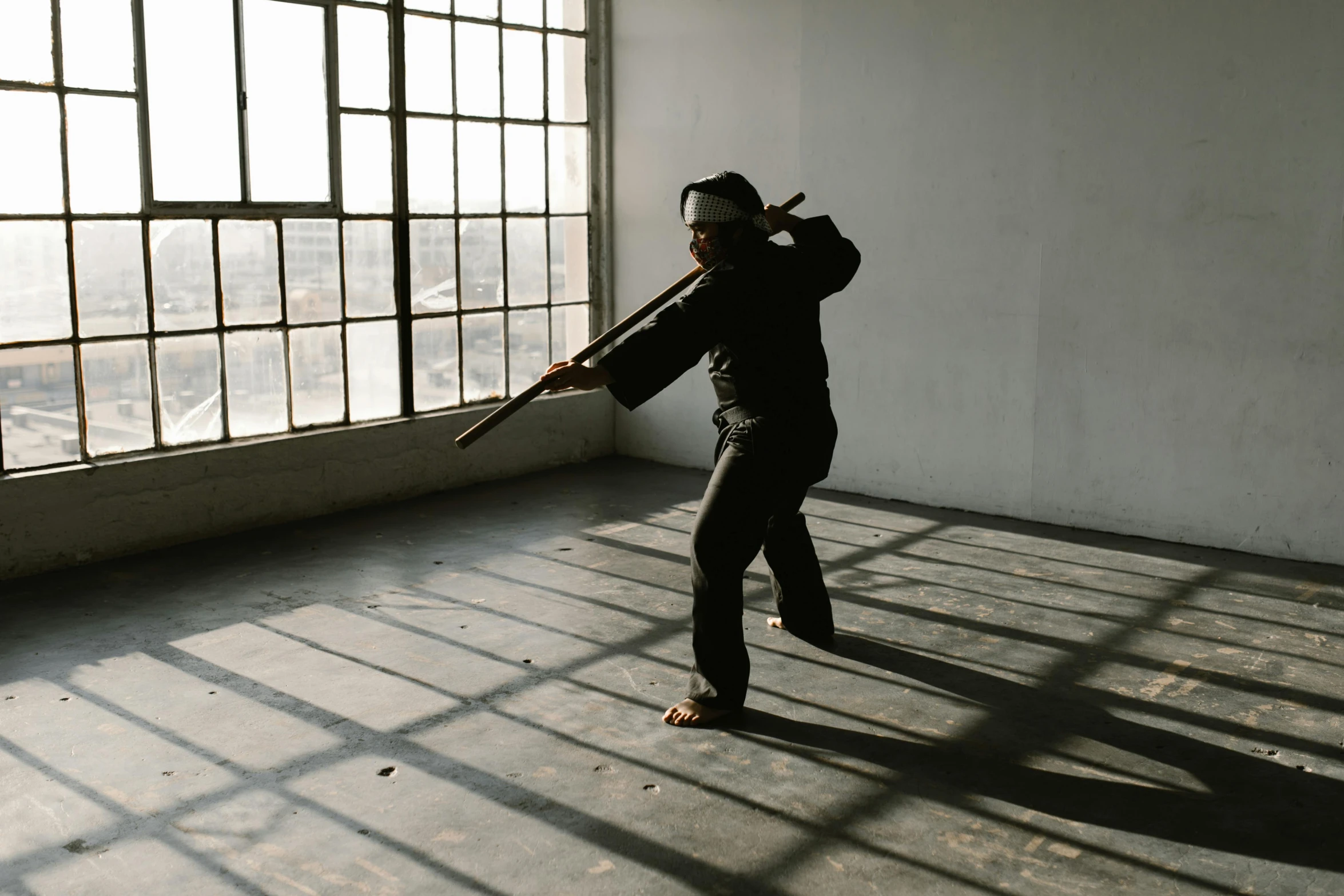 a man holding a baseball bat in an empty room, inspired by Ma Quan, unsplash, visual art, wielding kunai, fighting posture, black, manuka