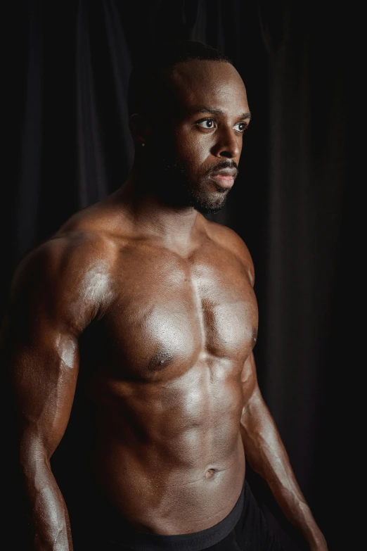 a shirtless man standing in front of a black background, inspired by Terrell James, set against a white background, showing off his muscles, instagram photo, covered in oil