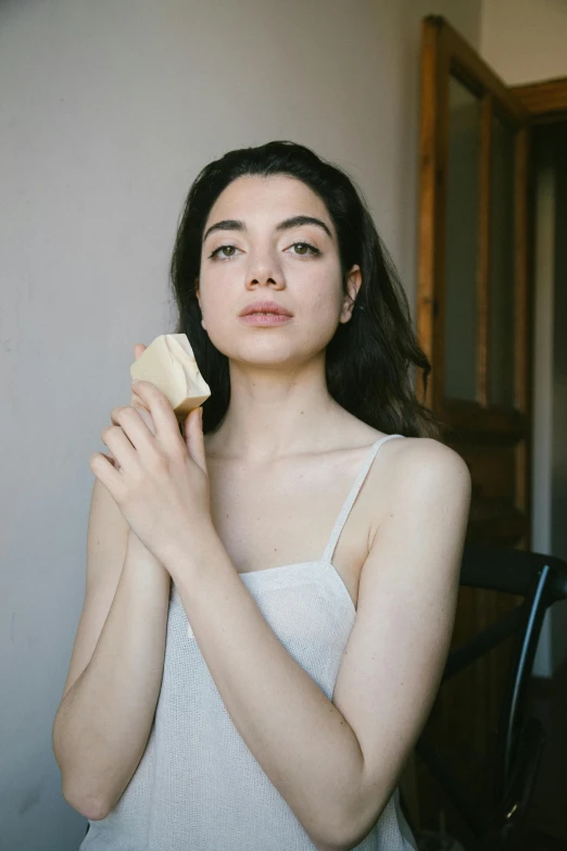 a woman brushing her hair with a brush, inspired by Elsa Bleda, reddit, renaissance, clean shaven face, bread, charli xcx, hand model