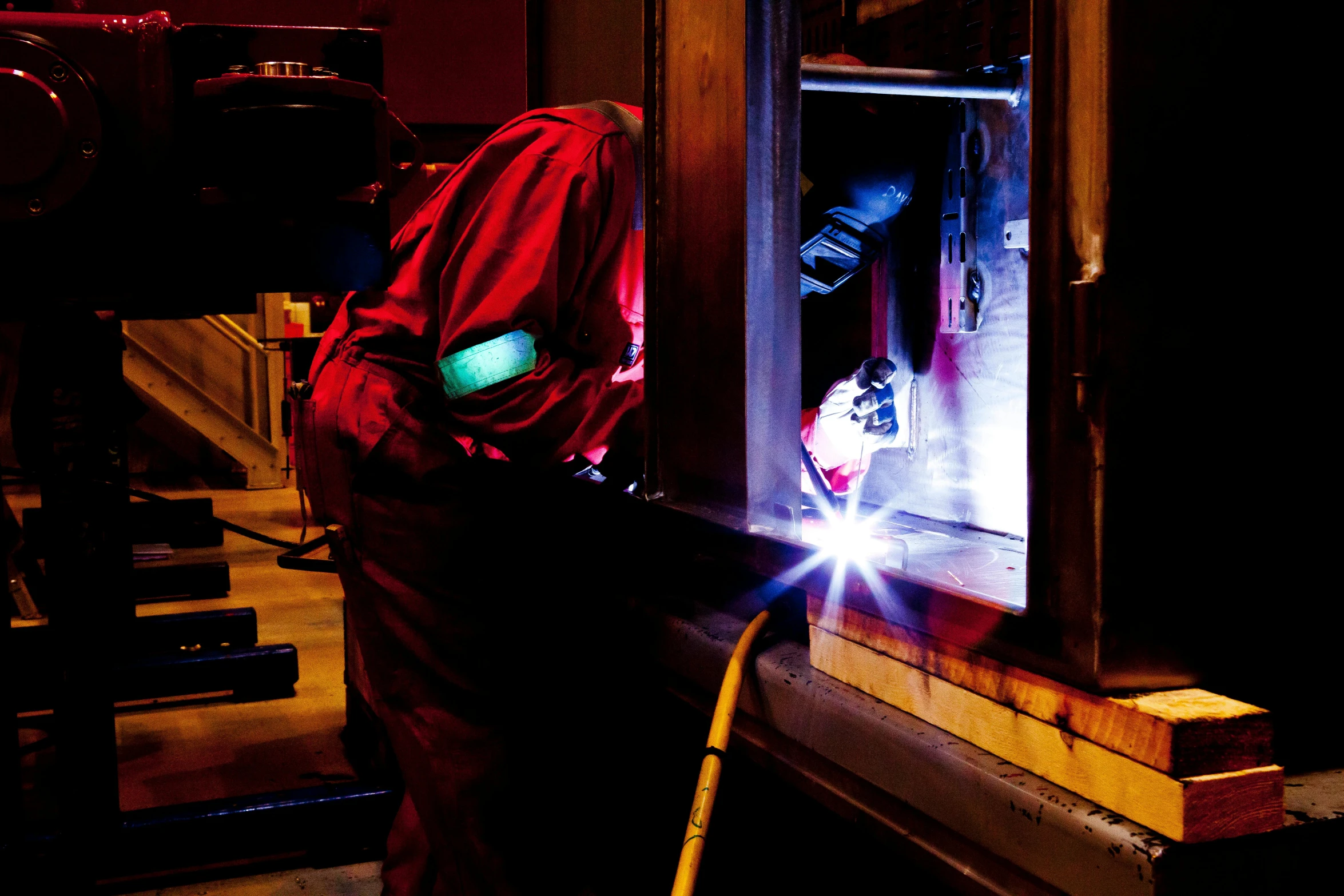 a welder working on a piece of wood, by Bradley Walker Tomlin, pexels contest winner, renaissance, about to enter doorframe, night time, flowers around, thumbnail