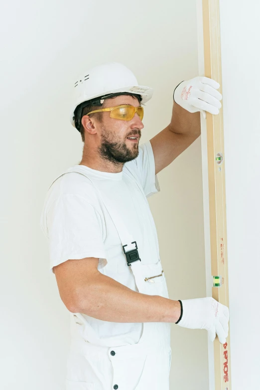 a man that is standing in front of a wall, hard hat, white walls, tools, profile image