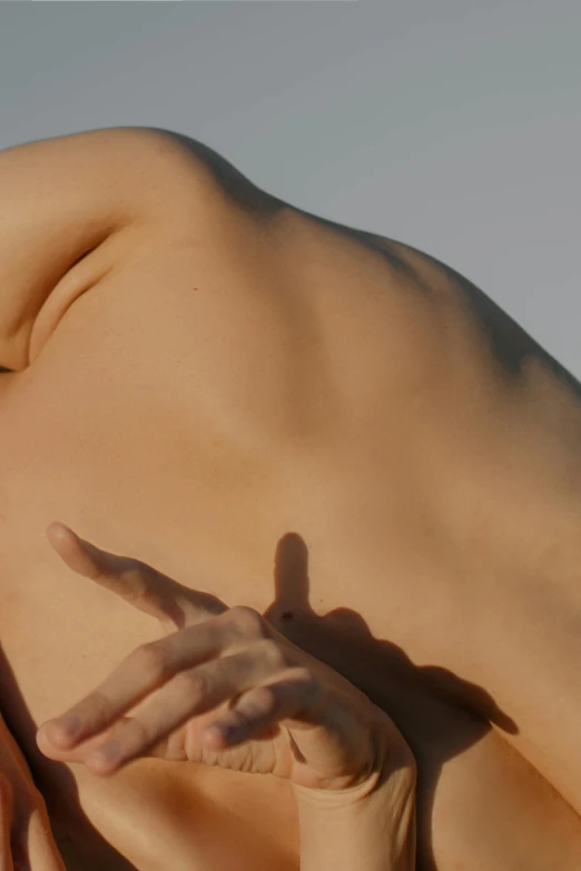 a naked woman laying on top of a bed, inspired by Ren Hang, unsplash, showing her shoulder from back, sun behind him, silicone skin, photorealistic skin texture