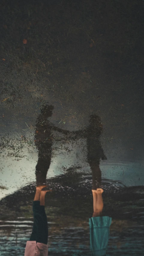 a couple of people standing on top of a surfboard, an album cover, by Attila Meszlenyi, pexels contest winner, conceptual art, puddle of water on the floor, glitter gif, standing in a dark, mirrored