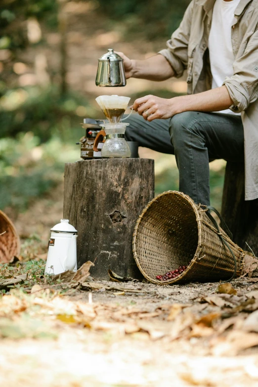 a man sitting on a stump in the woods, coffee machine, food styling, gourmet and crafts, brown