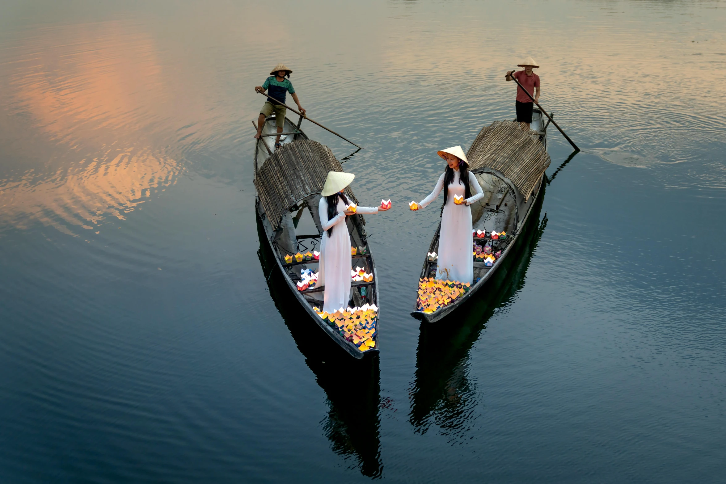 a couple of boats that are sitting in the water, inspired by Steve McCurry, pexels contest winner, conceptual art, ao dai, two hovering twin nuns, national geographic ”, holiday season