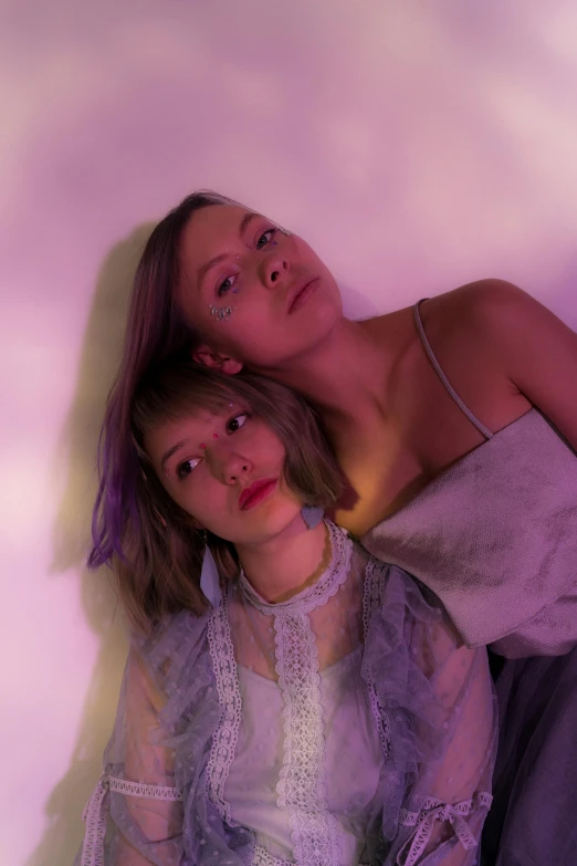 a couple of women sitting next to each other, an album cover, trending on pexels, purple volumetric lighting, sydney sweeney, portrait pose, isolate translucent