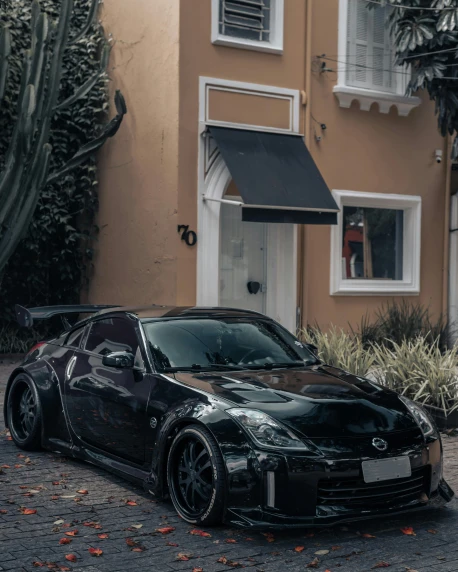 a black sports car parked in front of a building, by Matteo Pérez, pexels contest winner, perfectly shaded, at home, slightly smiling, samurai vinyl wrap