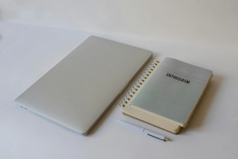 a laptop computer sitting on top of a table next to a notebook, by Carey Morris, postminimalism, silver，ivory, ultra accurate, overview, grayish