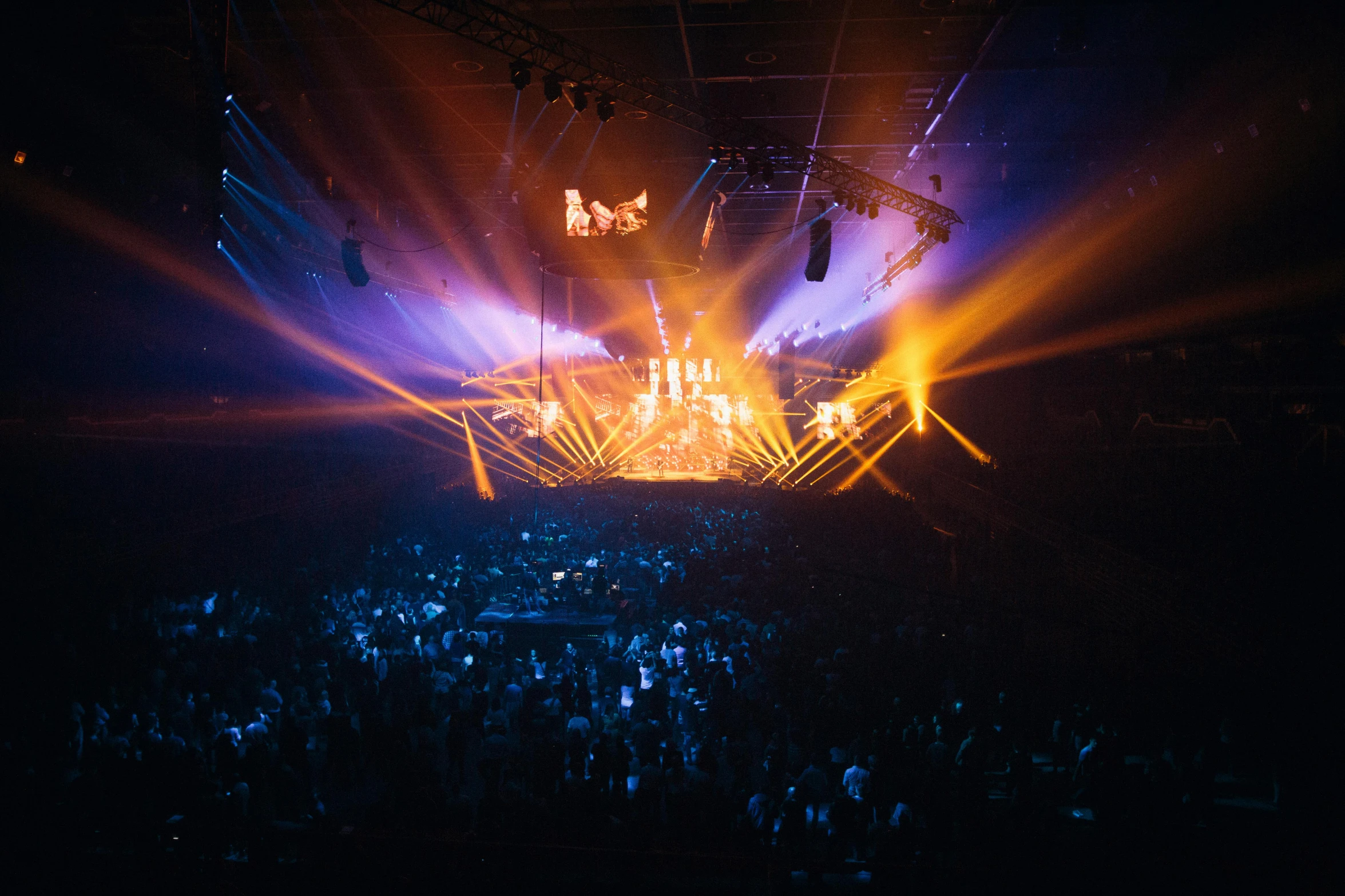 a large crowd of people at a concert, by Sebastian Spreng, unsplash contest winner, light and space, theatrical lighting, arena background, mezzanine, holy glow