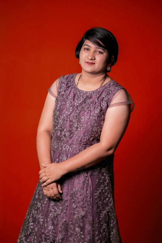 a woman in a purple dress posing for a picture, in red background, ritu kumar, full color photograph, ((portrait))