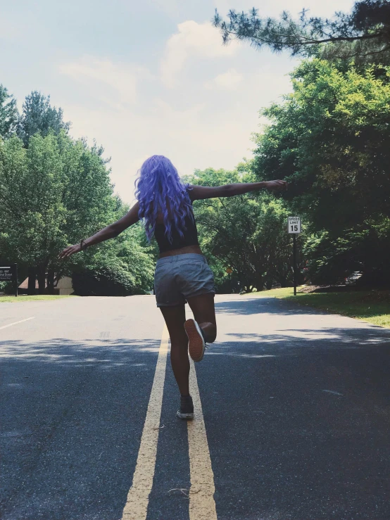 a woman with purple hair riding a skateboard down a street, by Dulah Marie Evans, girl walking in forest, ((purple)), ariana grande photography, rainbow road