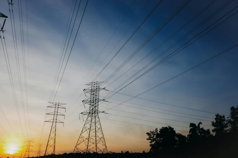 power lines are silhouetted against the setting sun, pexels contest winner, fan favorite, multicoloured, cinematic atmospheric photo, a green