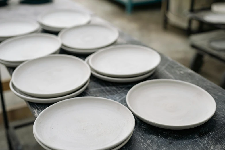 a bunch of white plates sitting on top of a table, inspired by Lewis Henry Meakin, wet clay, ready to eat, matte finish, 10k