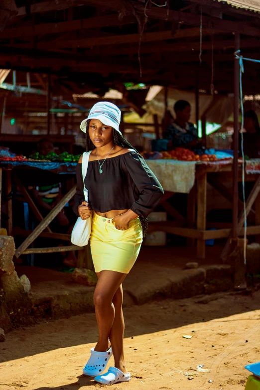 a woman standing in front of a fruit stand, an album cover, pexels contest winner, light skinned african young girl, miniskirt, somalia, street wear