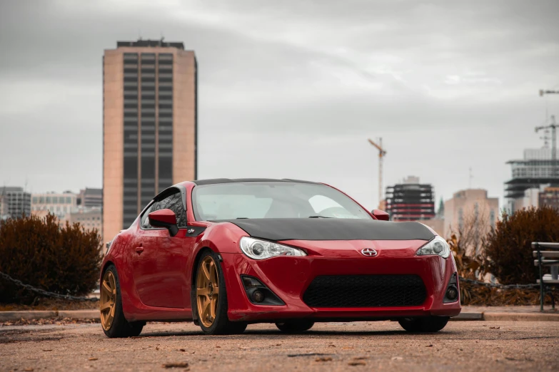 a red sports car parked in a parking lot, a picture, by Austin English, pexels contest winner, hurufiyya, red gold black, 2013 scion tc, 2 5 6 x 2 5 6, on a street race track