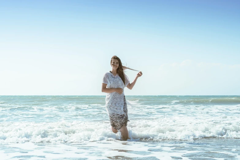 a woman standing in the ocean holding a baseball bat, a portrait, inspired by Pierre Puvis de Chavannes, unsplash, white lace clothing, happy italian beach scene, wearing a dress made of water, phoebe tonkin