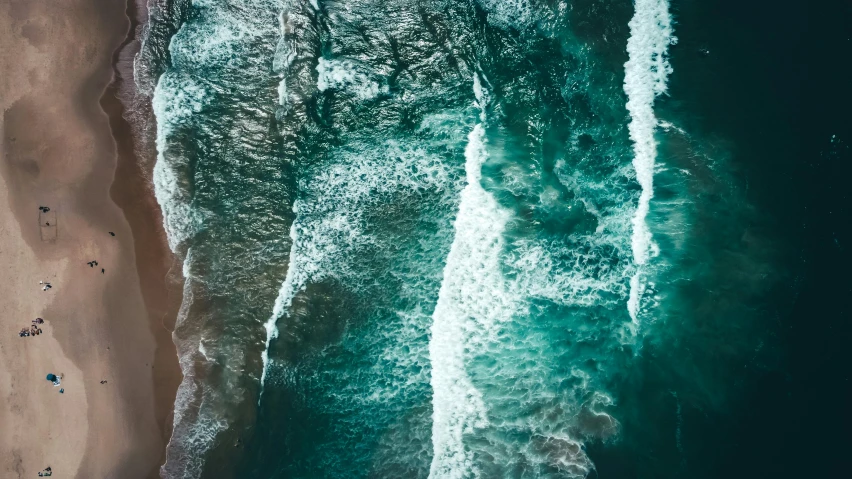 a large body of water next to a sandy beach, an album cover, inspired by Elsa Bleda, pexels contest winner, mutiversal tsunami, high angle close up shot, 4 k vertical wallpaper, water cascading