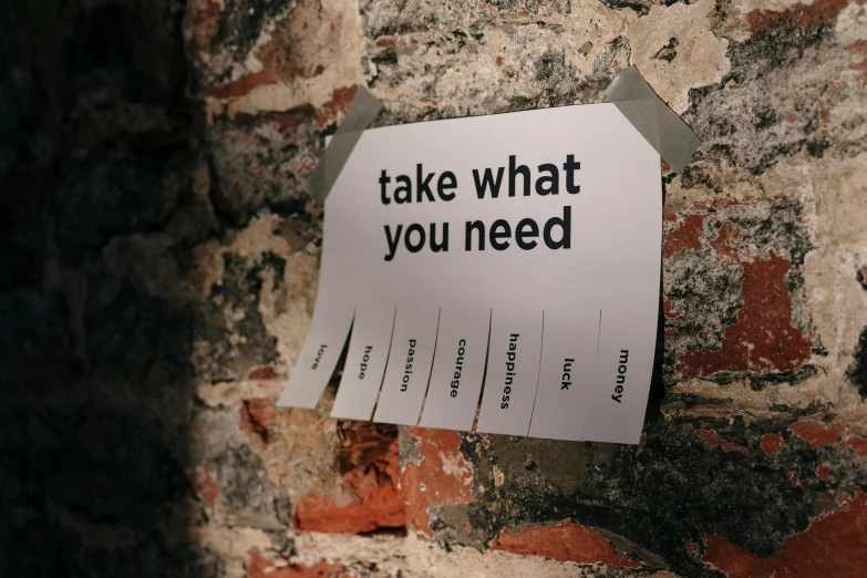 a sign on a brick wall that says take what you need, a poster, unsplash, paper cut out, archive material, injured, labels