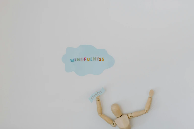 a wooden mannequin standing in front of a white wall, by Arabella Rankin, minimalism, puffy sticker, peaceful cloud, kindness, floating in mid - air