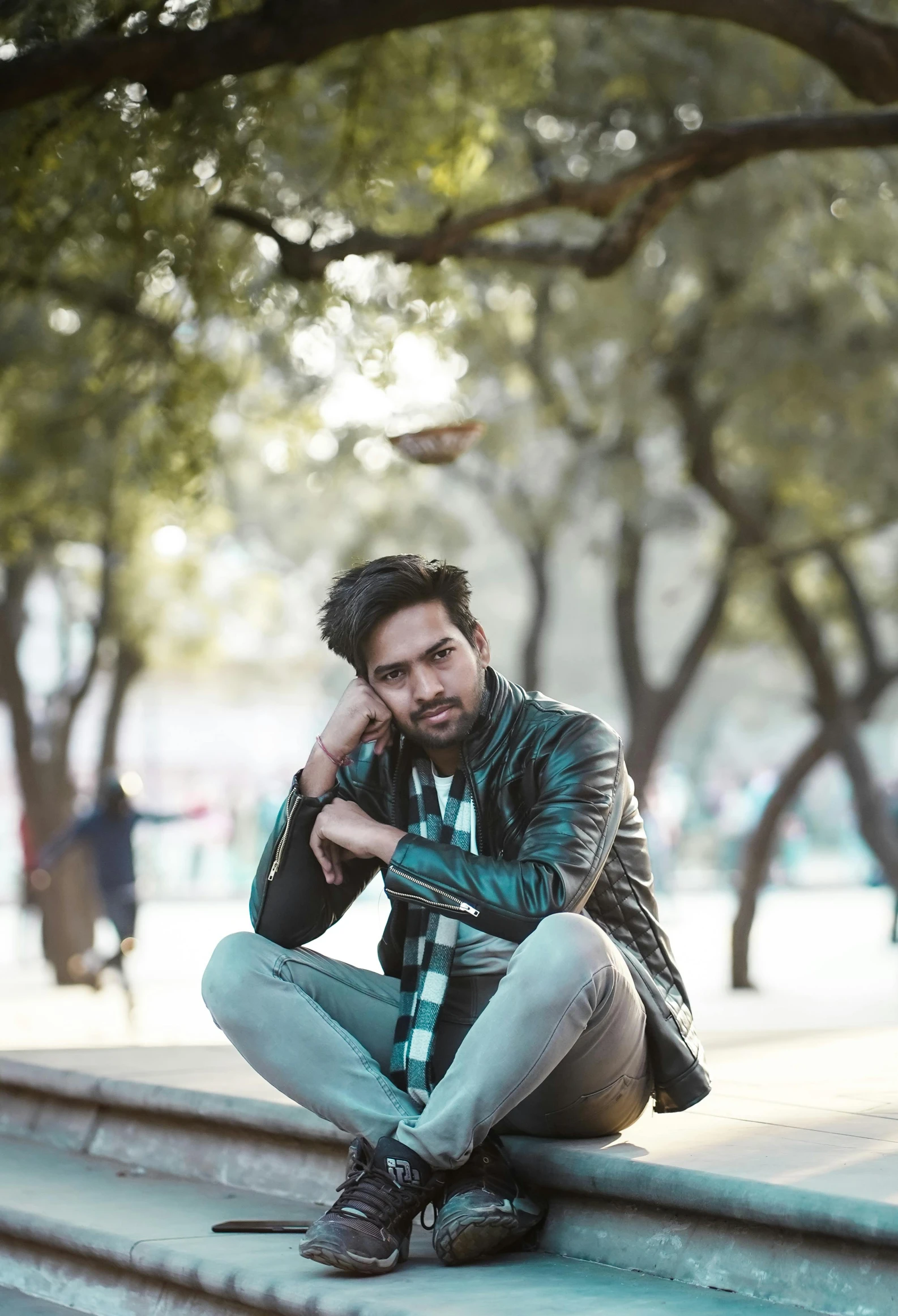 a man sitting on steps talking on a cell phone, a picture, by Niko Henrichon, pexels contest winner, a portrait of rahul kohli, cute pose, sitting on a park bench, indian