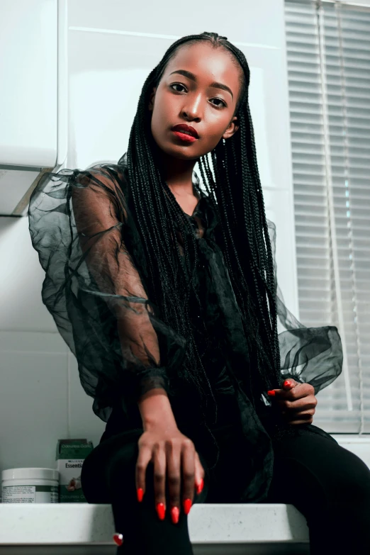 a woman sitting on a counter in a kitchen, inspired by Lily Delissa Joseph, trending on pexels, afrofuturism, long black braids, portrait willow smith, in a black chiffon layered robe, ((portrait))