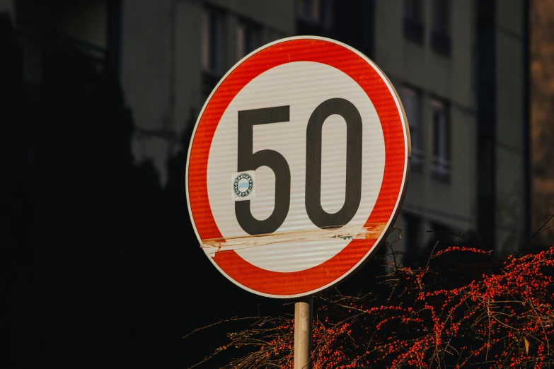 a close up of a street sign with a building in the background, by Matija Jama, unsplash, hyperrealism, 5 0 years old, light speed, countdown, -step 50