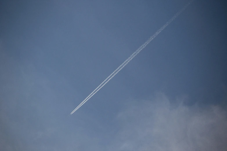 a plane that is flying in the sky, by Peter Churcher, minimalism, particulate, paul barson, low-angle, environmental