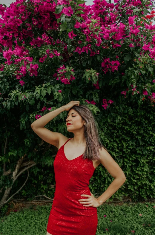 a woman in a red dress posing for a picture, an album cover, inspired by Elsa Bleda, pexels contest winner, bougainvillea, red tank-top, profile image, vine covered