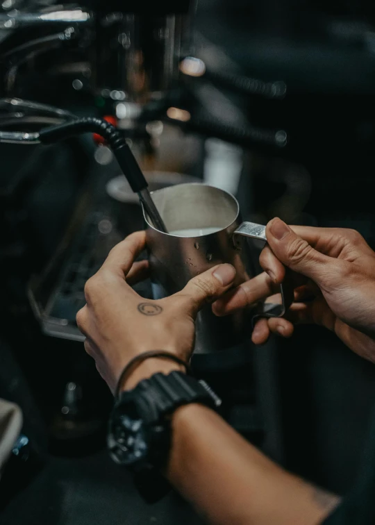a bari bari serving a cup of coffee, by Frederik Vermehren, pexels contest winner, biker, dark matte metal, highly polished, aussie baristas