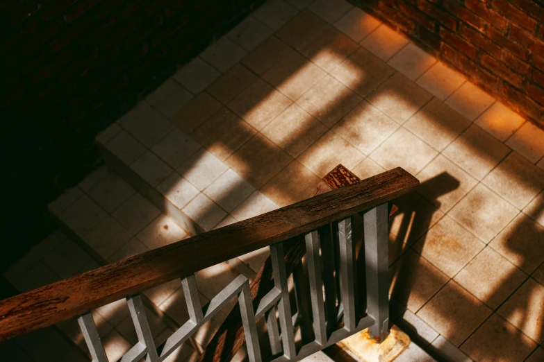 a close up of a staircase in a building, inspired by Elsa Bleda, pexels contest winner, light and space, brown, beams of sunlight, isometric staircase, location of a dark old house