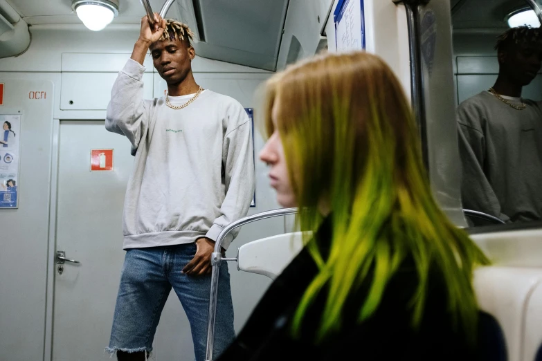 a man standing on top of a train next to a woman, trending on pexels, green feathery hair, heron preston, playboi carti, medium yellow blond hair
