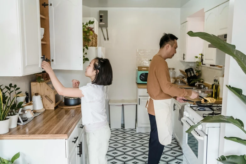 a man and a woman standing in a kitchen, by Julia Pishtar, pexels contest winner, fan favorite, japanese collection product, panoramic view of girl, holding a baguette