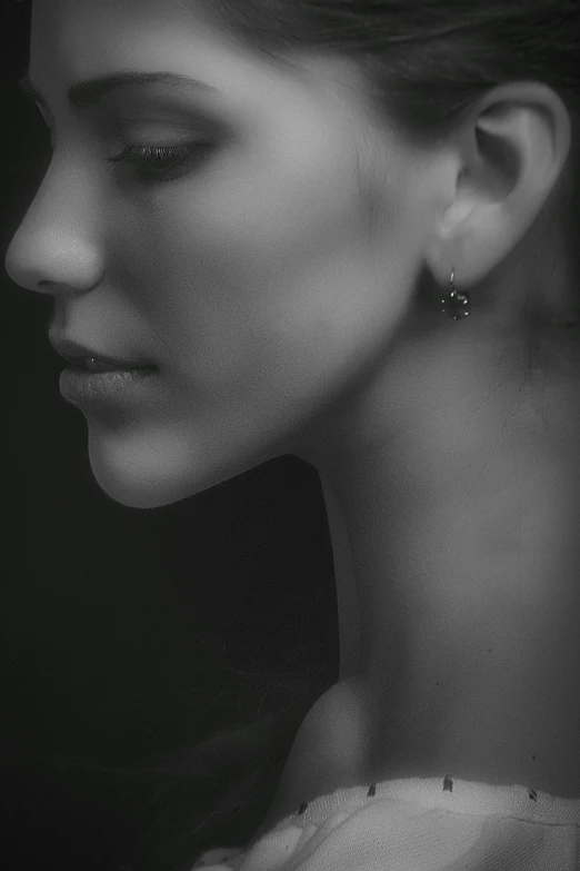 a black and white photo of a woman, by irakli nadar, digital art, earring, small, profile pic, esthetic photo