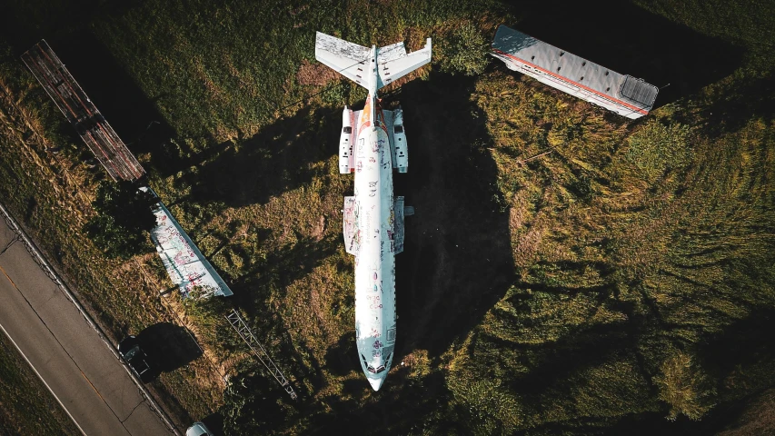 a large airplane sitting on top of a lush green field, a portrait, pexels contest winner, auto-destructive art, abandoned space station, drone photo, instagram post, thumbnail