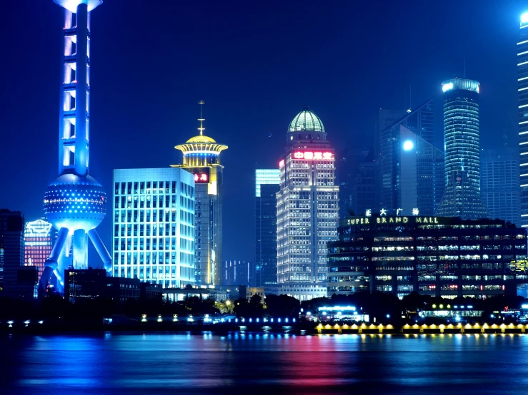 the city skyline is lit up at night, a digital rendering, inspired by Cheng Jiasui, pexels, building along a river, taken in 1 9 9 7, slide show, college