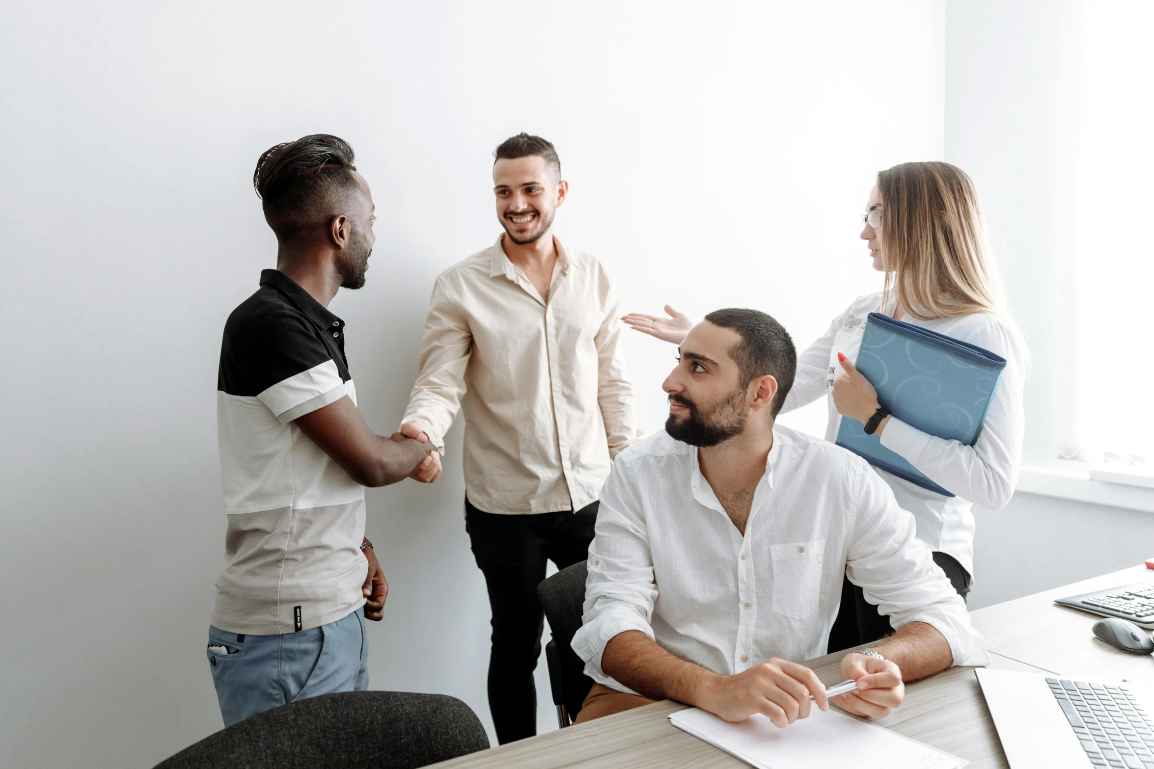 a group of people standing around a wooden table, on a white table, background image, professional profile picture, white male