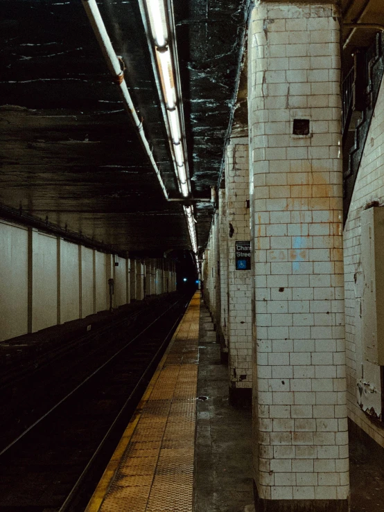 a subway station with a train on the tracks, inspired by Elsa Bleda, unsplash contest winner, post apocalyptic new york, square lines, 2000s photo, fan favorite