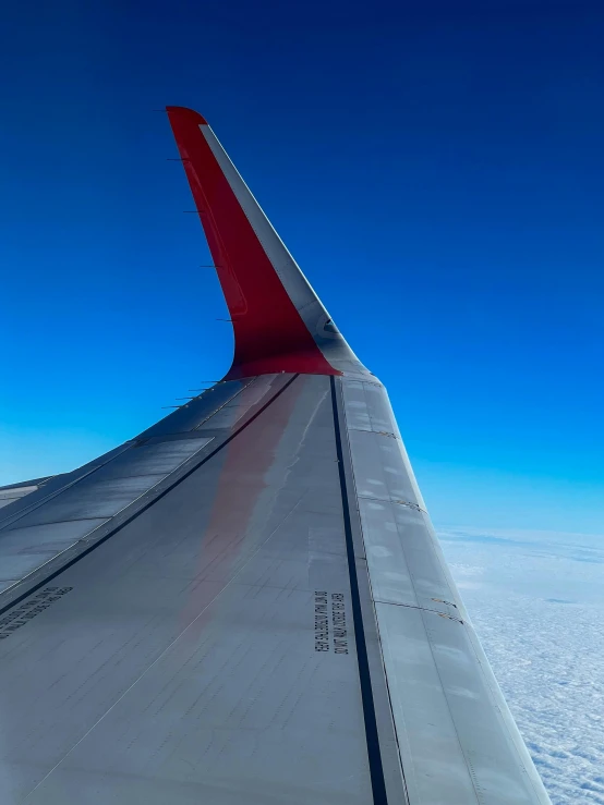 the wing of an airplane flying above the clouds, by Sven Erixson, curved red arrow, north pole, smooth edges, taken in 2 0 2 0