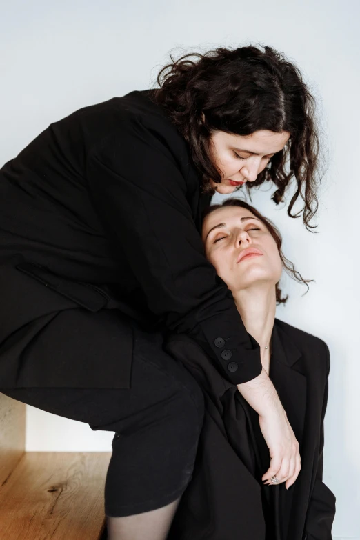 a woman sitting on top of a man in a suit, inspired by Marina Abramović, woman holding another woman, profile image, brunettes, sleepy